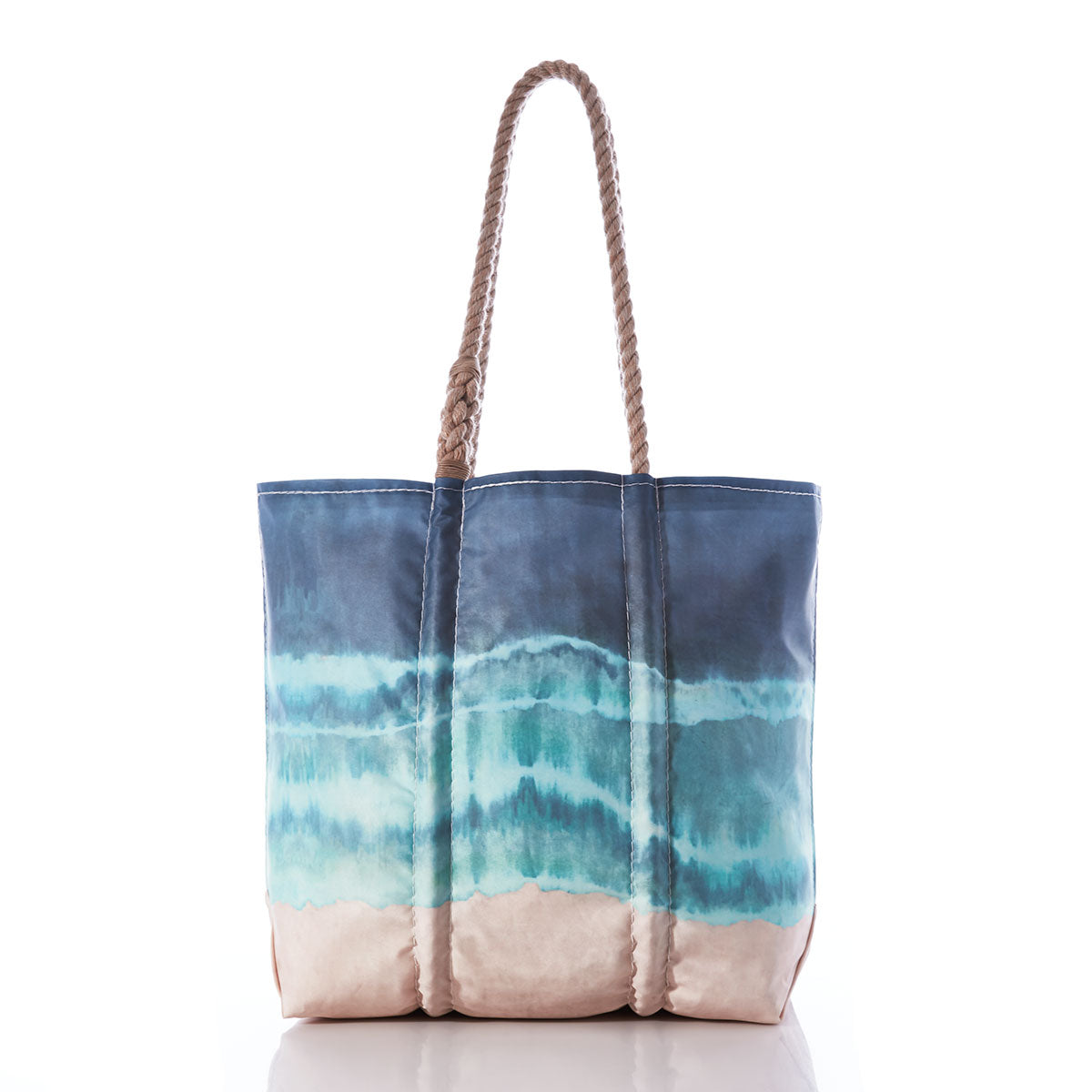 Sea Bags Zip Top Shoreline Tie Dye Medium Tote, crafted in the style of a recycled sail cloth bag, features braided handles and a blue and green watercolor wave design with a sand-colored base. Shown on a white background, this zip top tote is both stylish and practical for seaside adventures. by Sea Bags