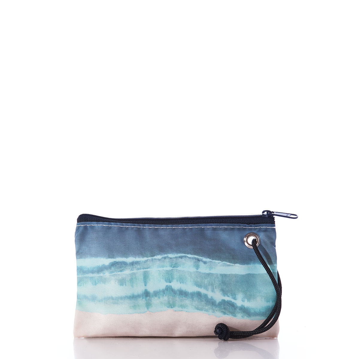 The Shoreline Tie Dye Wristlet by Sea Bags is a small zippered pouch with a wrist strap, showcasing a blue and beige tie dye watercolor design reminiscent of a beach bag, displayed against a white background. by Sea Bags