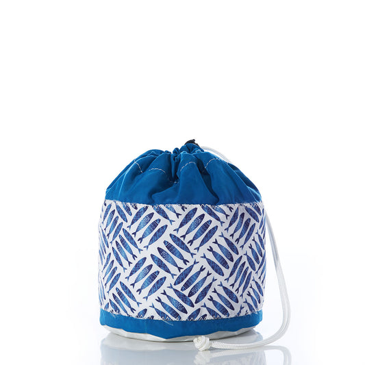The Sea Bags Fish Print Ditty Bag, made from recycled sail bag material for enhanced durability, features a blue and white fish print design with a drawstring closure. Displayed upright on a reflective surface against a white background, this weather-resistant organizer is ideal for storing luggage or everyday essentials. by Sea Bags