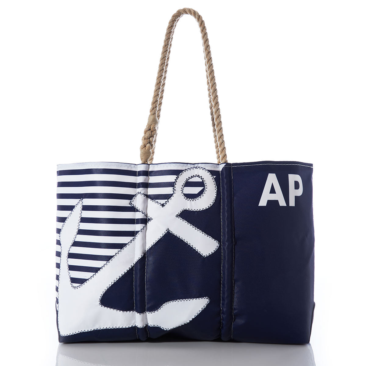 Introducing the Sea Bags Custom Monogram Breton Stripe Anchor Large Tote—a stylish navy blue nautical tote bag crafted from durable, eco-friendly recycled sail cloth. It features a striking large white anchor design, classic striped panel, sturdy rope handles, and can be personalized with your initials e.g., AP printed on one side. by Sea Bags