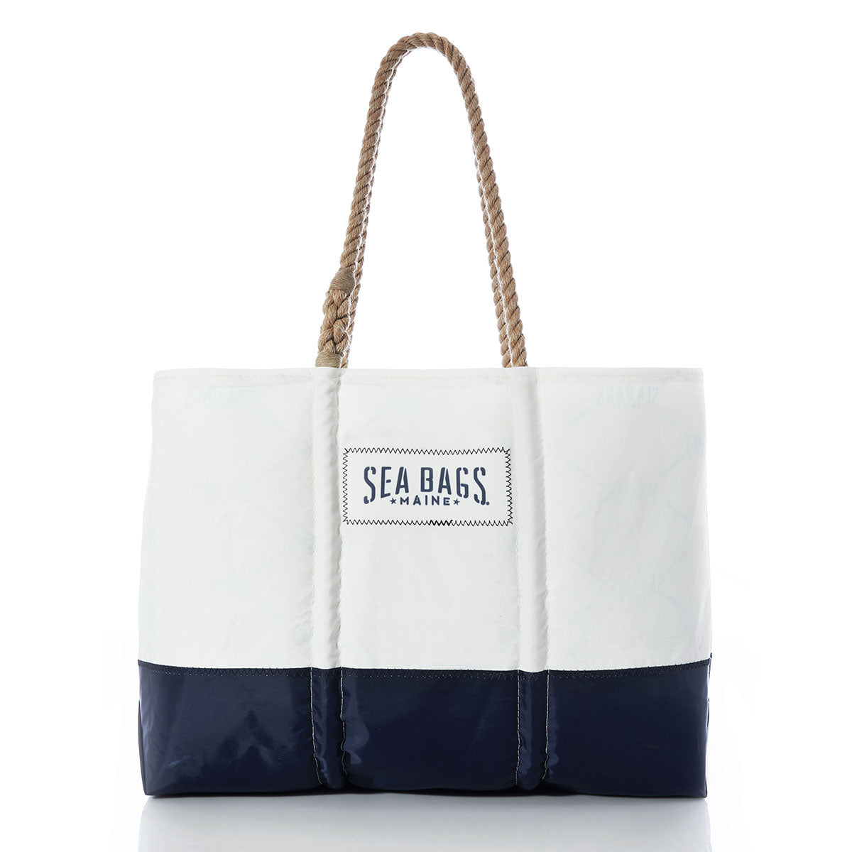 Sailmaker’s Tote with Clasp and Hanging Pocket by Sea Bags, crafted from recycled sail cloth in white and navy with rope handles and a Sea Bags label on the front, shown against a white background. by Sea Bags