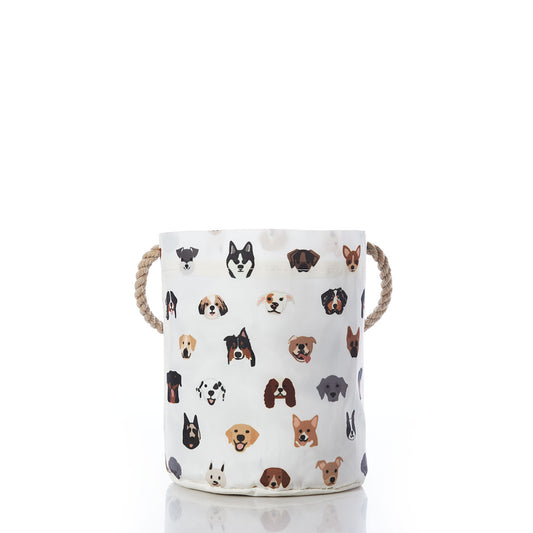 The Sea Bags Popular Pups Print Bucket Bag is a cylindrical white pet organizer featuring rope handles and decorated with a playful pattern of various dog breed faces, shown centered on a white background. by Sea Bags
