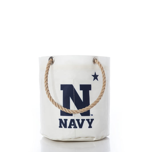 Introducing the US Naval Academy Beverage Bucket by Sea Bags—a unique white bucket-style bag crafted from recycled sail cloth. It features a sturdy rope handle, bold navy blue lettering with the letter N and the word NAVY, plus a striking star symbol. Both durable and stylish, this distinctive beverage bucket is perfect for showing your Midshipmen pride. by Sea Bags