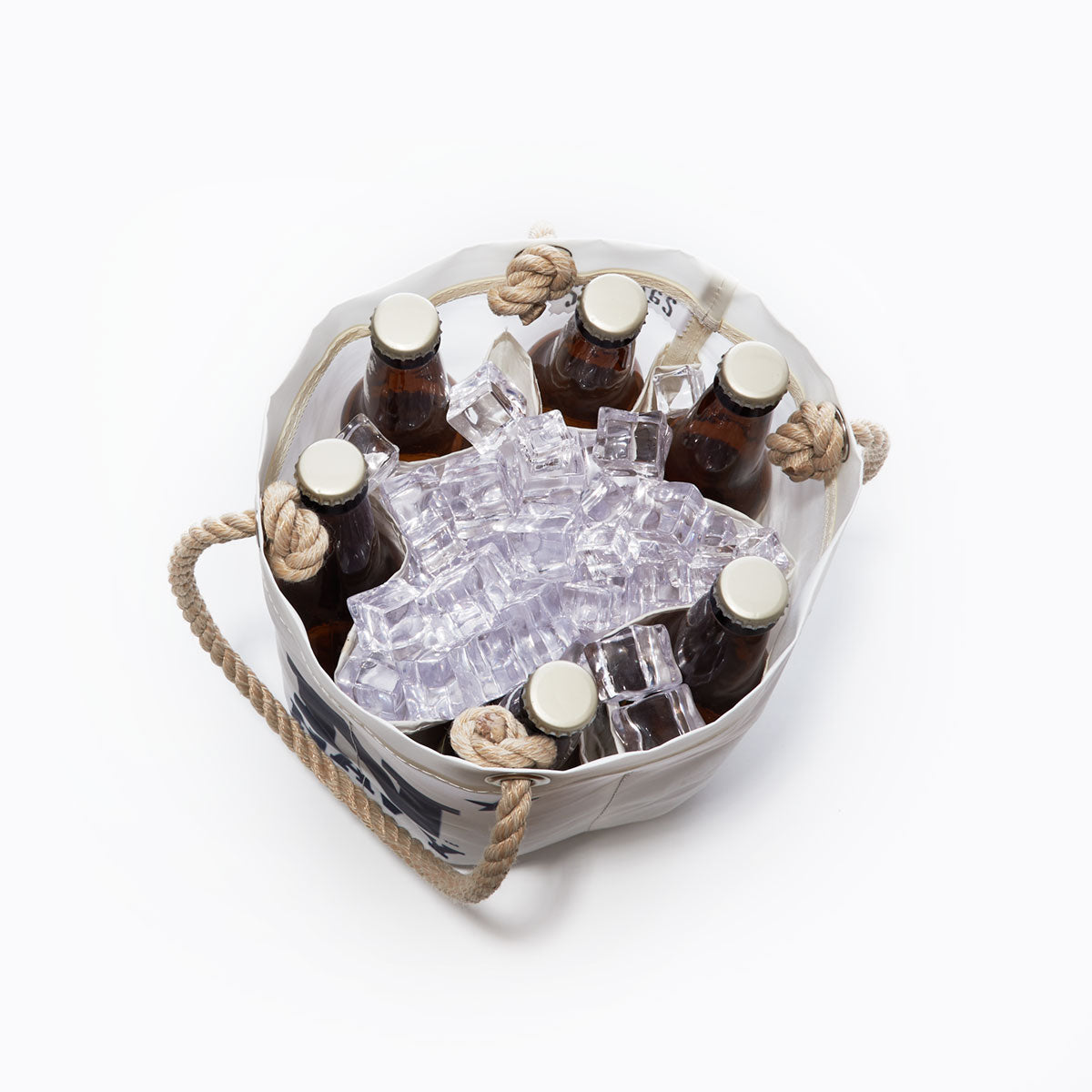 A top-down view shows the Sea Bags US Naval Academy Beverage Bucket, crafted from recycled sail cloth and styled after a classic Midshipmen cooler, holding six brown glass bottles with caps nestled in ice cubes on a white background. by Sea Bags