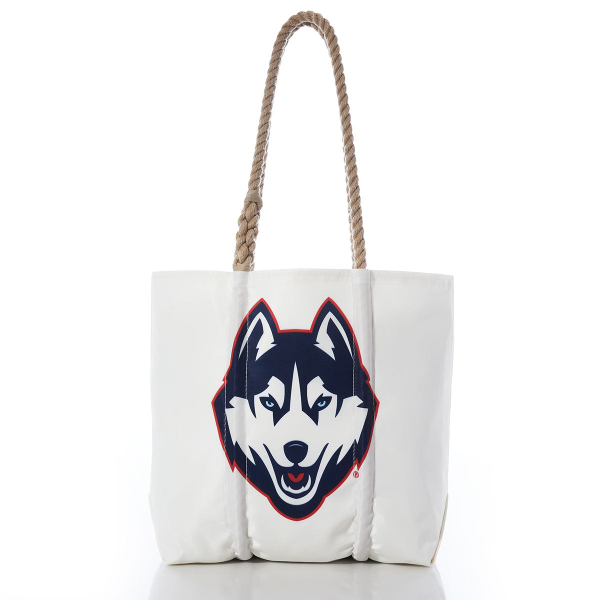 Introducing the UCONN Tote by Sea Bags—a white tote bag with sturdy hemp rope handles, featuring a large graphic of a husky dog’s face outlined in navy and red on the front. Finished with a collegiate hang tag for added style. by Sea Bags
