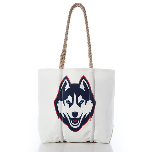 Introducing the UCONN Tote by Sea Bags—a white tote bag with sturdy hemp rope handles, featuring a large graphic of a husky dog’s face outlined in navy and red on the front. Finished with a collegiate hang tag for added style. by Sea Bags