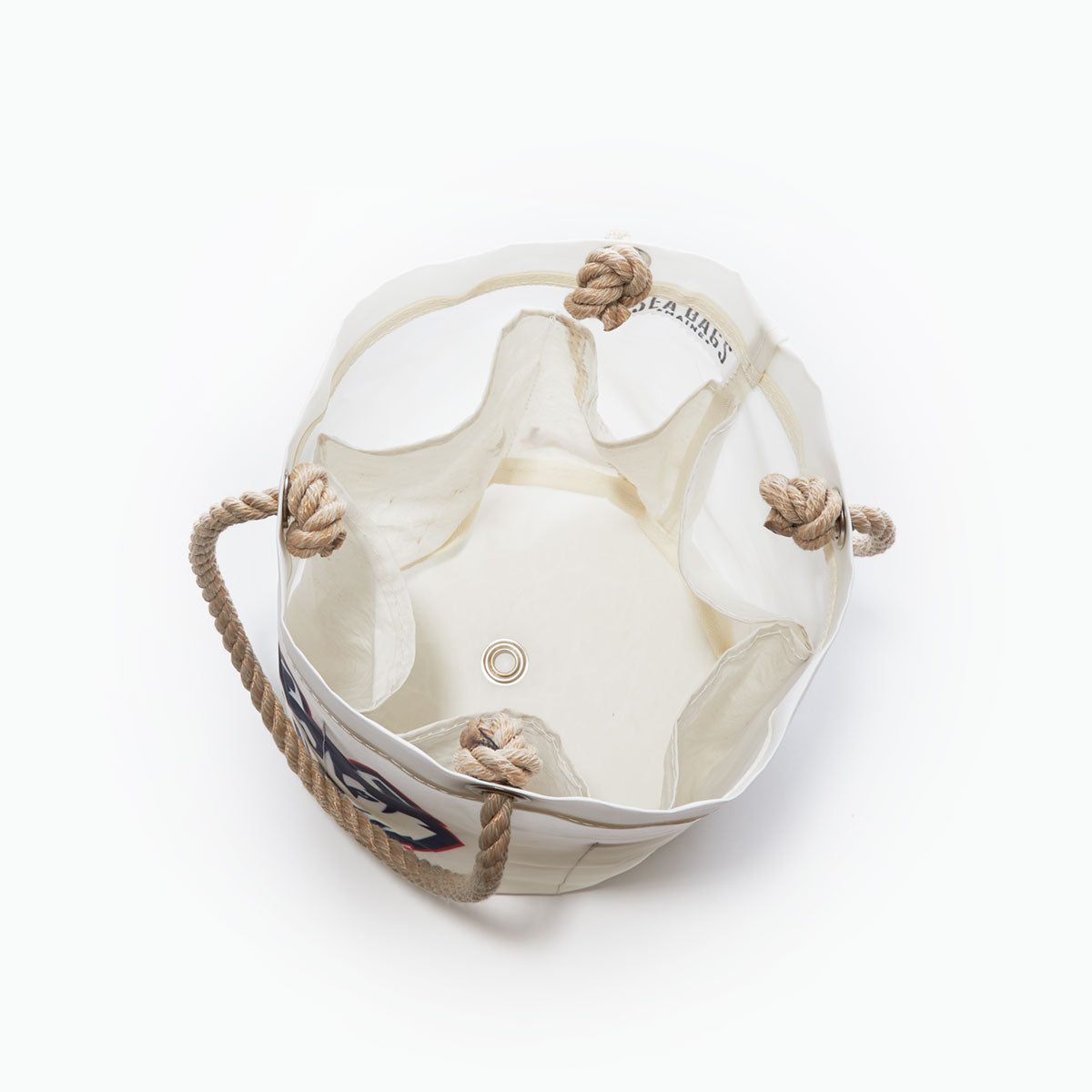 Top view of the UCONN Beverage Bucket by Sea Bags, crafted from recycled sail cloth with sturdy rope handles, a metal grommet at the base, and knotted rope accents along the inside rim—all on a white background—making it an ideal school spirit gift or a stylish organizer for any college dorm. by Sea Bags