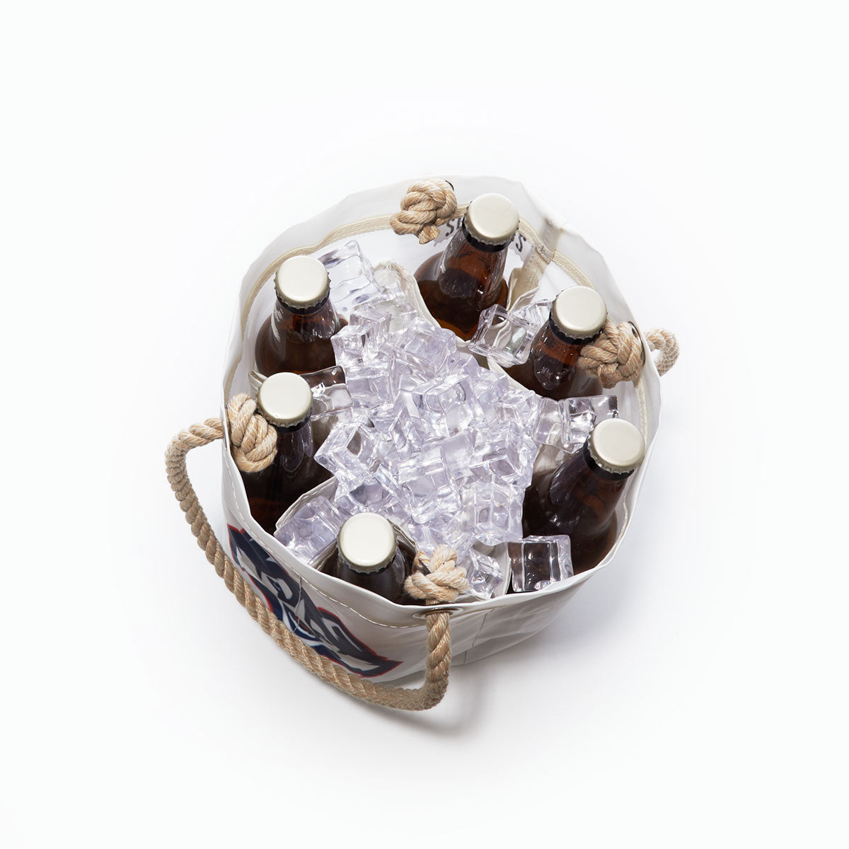 Five brown glass bottles with white caps are placed in a Sea Bags UCONN Beverage Bucket filled with ice cubes, shown from above against a white background—a perfect school spirit gift, or pair it with a college dorm organizer to keep your space chilled and tidy. by Sea Bags