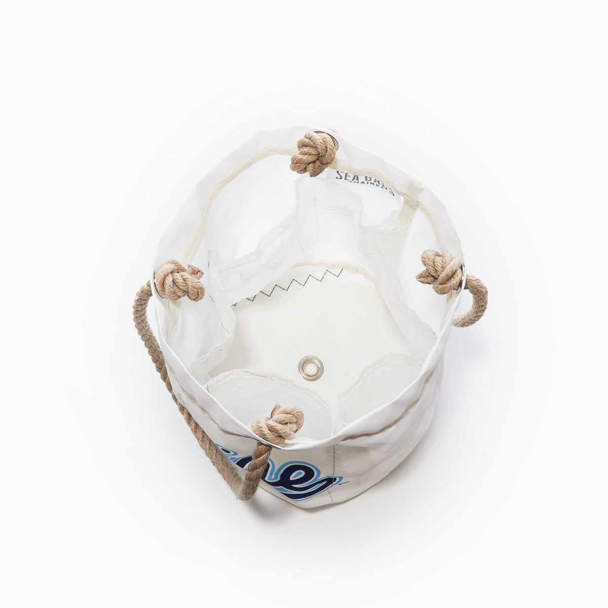 Top view of the UMaine Beverage Bucket by Sea Bags, crafted from recycled sail cloth in white with rope handles and knots, metal grommet at the base, and black zigzag stitching inside. by Sea Bags
