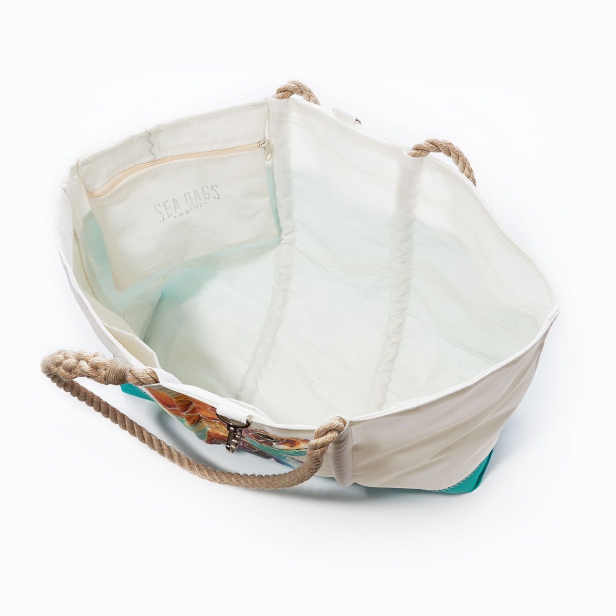 Multicolor Sea Turtle Ogunquit Beach Tote by Sea Bags with rope handles, an interior zippered pocket, and SEA BAGS printed inside. This recycled sail tote appears empty and is photographed against a white background. by Sea Bags