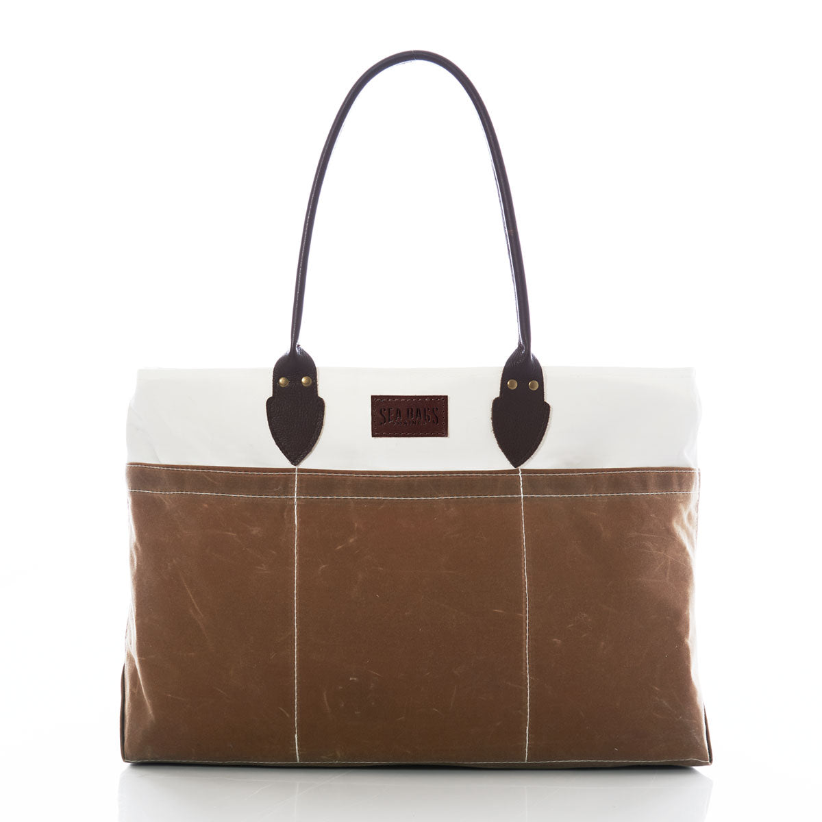 Tan Chebeague Large Travel Tote by Sea Bags, made from recycled sail cloth in brown and white tones, features dark handles, stitched vertical lines, and a rectangular front label, photographed on a white background. by Sea Bags