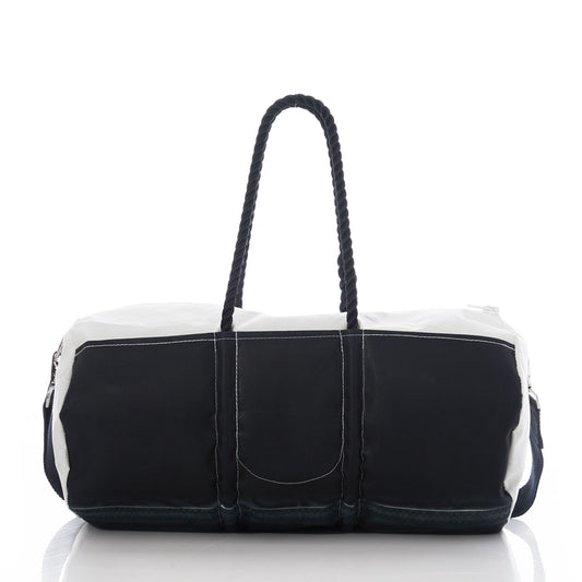 The Sea Bags Jolly Roger Duffel, featuring black and white rope handles and durable duffel bag construction, is displayed on a reflective surface with a white background. by Sea Bags