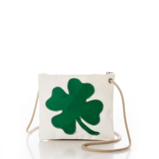 The Sea Bags Four Leaf Clover Slim Crossbody is a square white bag crafted from durable sail cloth, showcasing a prominent green four-leaf clover design on the front and finished with a beige strap—providing a sleek and chic alternative to traditional handbags, presented against a plain white background. by Sea Bags