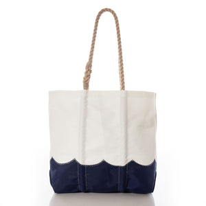 Sea Bags Wavy Seas Medium Tote, crafted from durable recycled sail cloth, features a thick rope handle and a navy blue scalloped bottom edge, shown against a white background. by Sea Bags