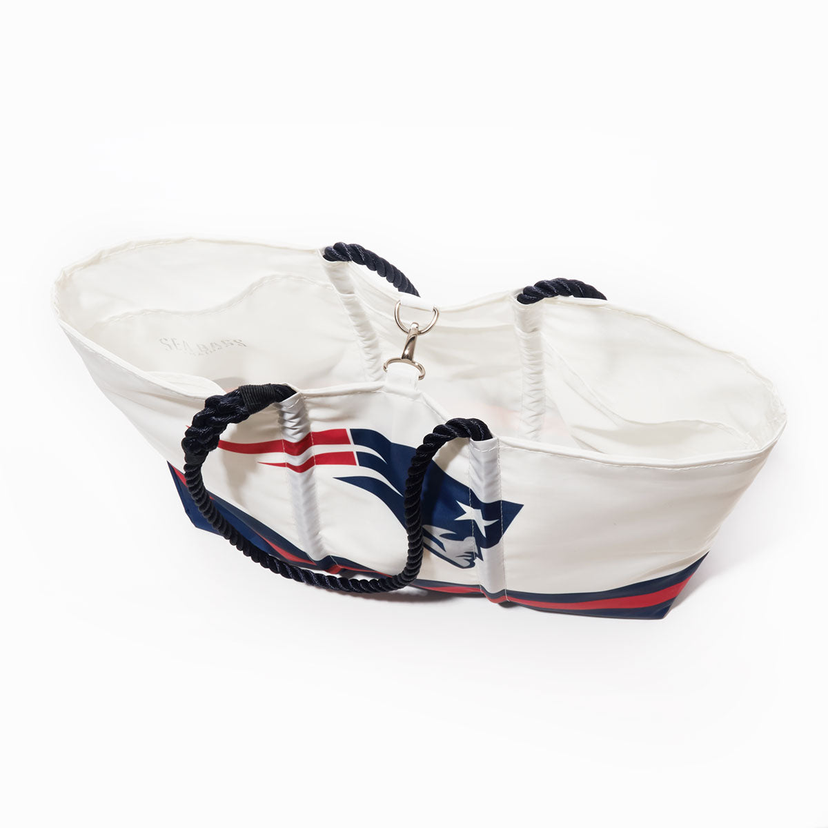 The New England Patriots Tailgate Tote by Sea Bags, crafted from recycled sail cloth, features navy blue rope handles and a bold Patriots logo printed on the side, displayed against a white background. by Sea Bags