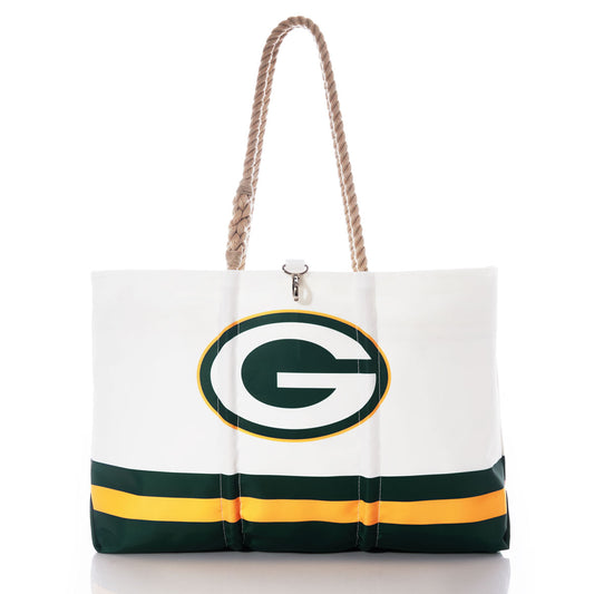 Carry your gear in style with the Green Bay Packers Tailgate Tote by Sea Bags. Made from recycled sail cloth, this white tote bag features sturdy rope handles, a bold Green Bay Packers “G” logo, and striking green and gold stripes near the bottom. Both fashionable and durable, it’s the perfect accessory to showcase your team pride. by Sea Bags