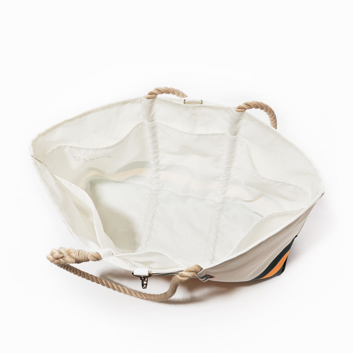 The Sea Bags Green Bay Packers Tailgate Tote is a large white canvas tote bag crafted from recycled sail cloth, featuring sturdy rope handles and an open top that reveals a spacious interior. Subtle brand marking appears near the top edge, making this versatile tote perfect for carrying all your essentials. by Sea Bags