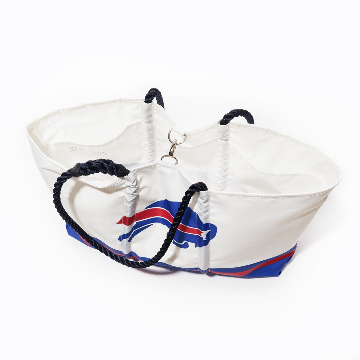 The Sea Bags Buffalo Bills Tailgate Tote is a white tote bag crafted from recycled sail cloth, featuring a blue rope handle and a stylized blue and red buffalo graphic on the side—ideal as a Bills tote for game days or as a durable tailgate accessory. Photographed against a white background. by Sea Bags