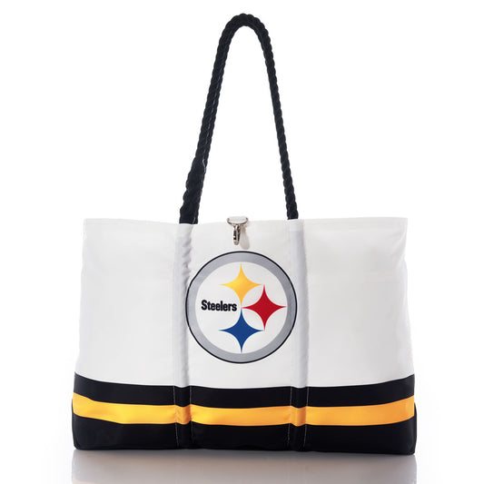 The Sea Bags Pittsburgh Steelers Tailgate Tote, crafted from recycled sail cloth for extra durability, features black handles, the Pittsburgh Steelers logo, and black and yellow stripes near the bottom; this distinctive bag is shown on a reflective surface. by Sea Bags