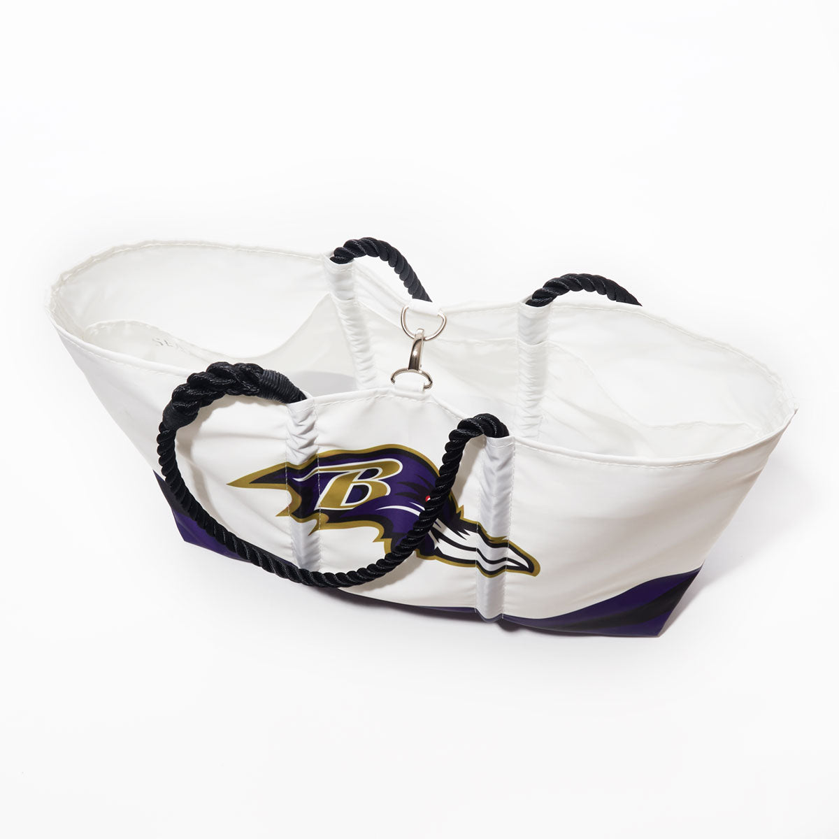 The Sea Bags Baltimore Ravens Tailgate Tote, crafted from recycled sail cloth, features a bold Baltimore Ravens logo in white and purple, complemented by black rope handles and shown against a plain white background. by Sea Bags
