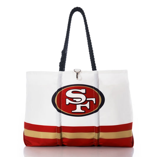 Show off your team spirit in style with the San Francisco 49ers Tailgate Tote by Sea Bags. This eco-friendly white tote features bold black handles, the iconic 49ers logo, and eye-catching red and gold stripes near the bottom—making it the perfect sustainable accessory for every fan. by Sea Bags