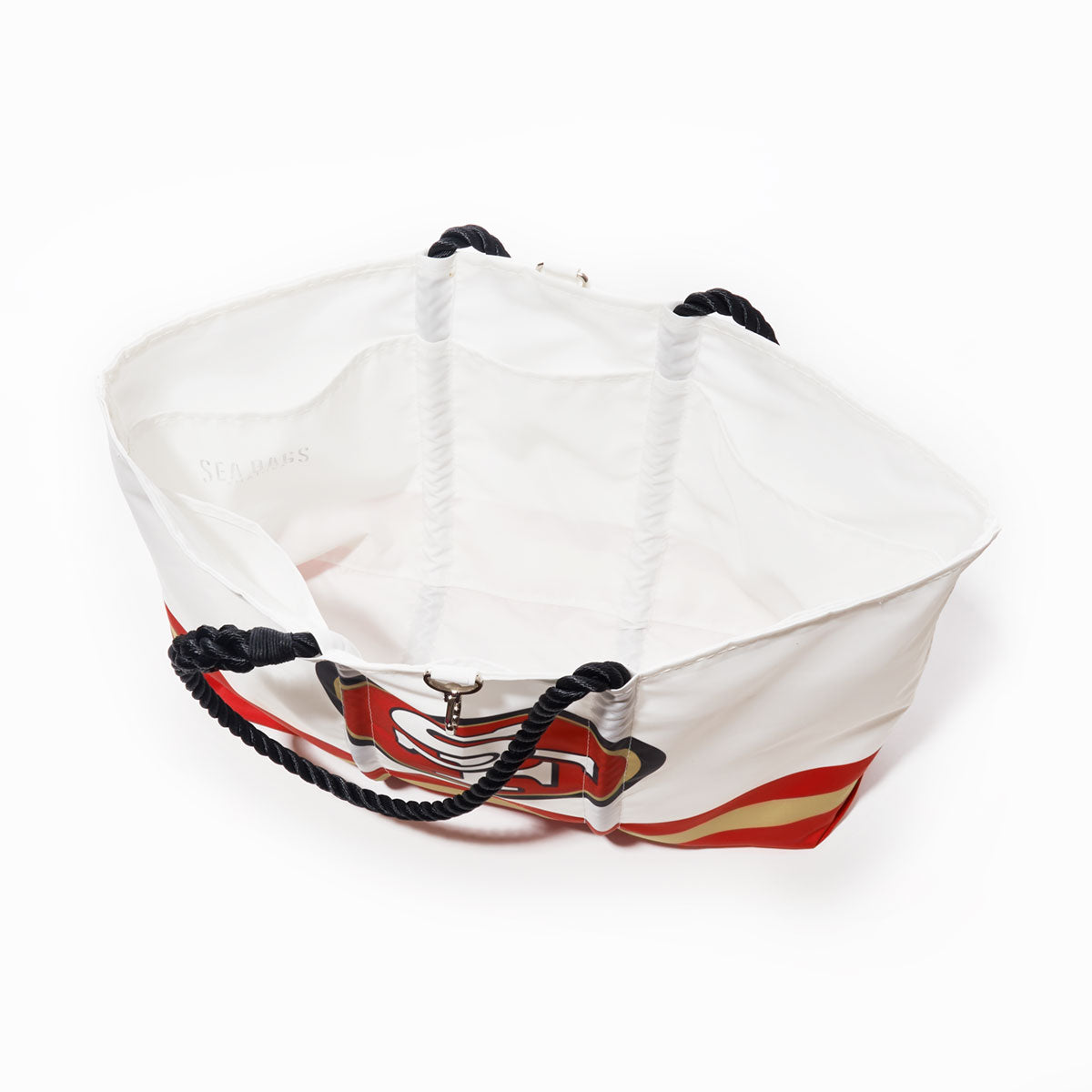 Introducing the San Francisco 49ers Tailgate Tote by Sea Bags—a white and red tote featuring nautical rope handles, an open top, and a bold printed anchor design on the exterior. Made from recycled sail cloth, this stylish logo bag is both spacious and eco-friendly. by Sea Bags
