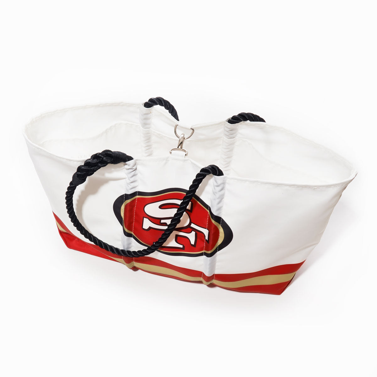 The Sea Bags San Francisco 49ers Tailgate Tote is a white recycled sail cloth bag with black rope handles, accented by red and gold stripes and the iconic SF logo. Photographed on a plain white background, this eco-friendly tote is ideal for displaying your team pride at your next football tailgate. by Sea Bags