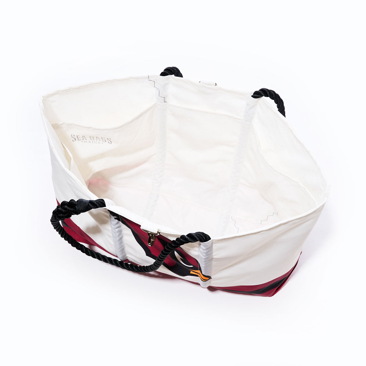 Arizona Cardinals Tailgate Tote by Sea Bags, featuring black rope handles and red accents, crafted from recycled sail cloth; displayed empty from a top-down angle against a white background. by Sea Bags