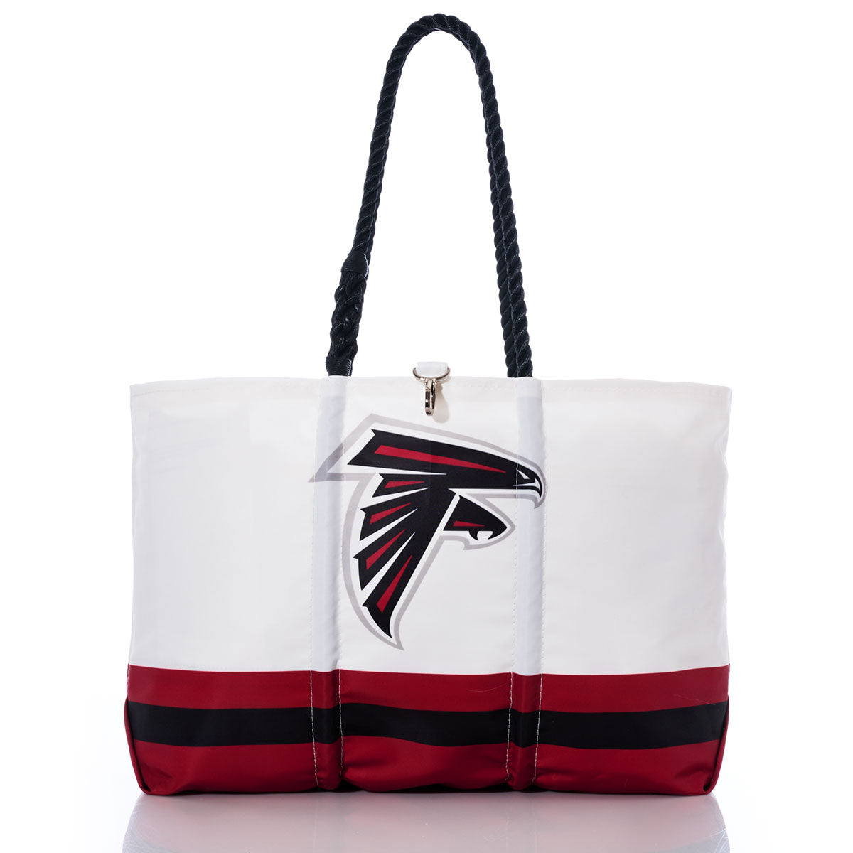 Flaunt your team pride with the Atlanta Falcons Tailgate Tote by Sea Bags, expertly crafted from recycled sail cloth. This chic white tote showcases durable black handles, the iconic Atlanta Falcons NFL logo, and striking red and black stripes along the bottom—all beautifully captured on a clean white backdrop. by Sea Bags
