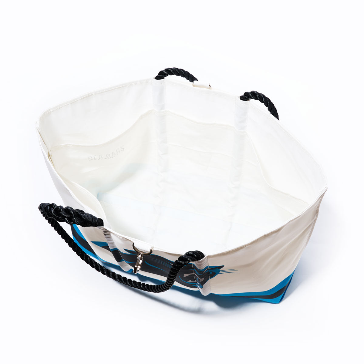 The Carolina Panthers Tailgate Tote by Sea Bags—crafted from recycled sail cloth for durability and eco-friendliness—features black rope handles and a spacious interior, shown open against a plain white background, making it the perfect practical yet stylish accessory for Panthers fans. by Sea Bags