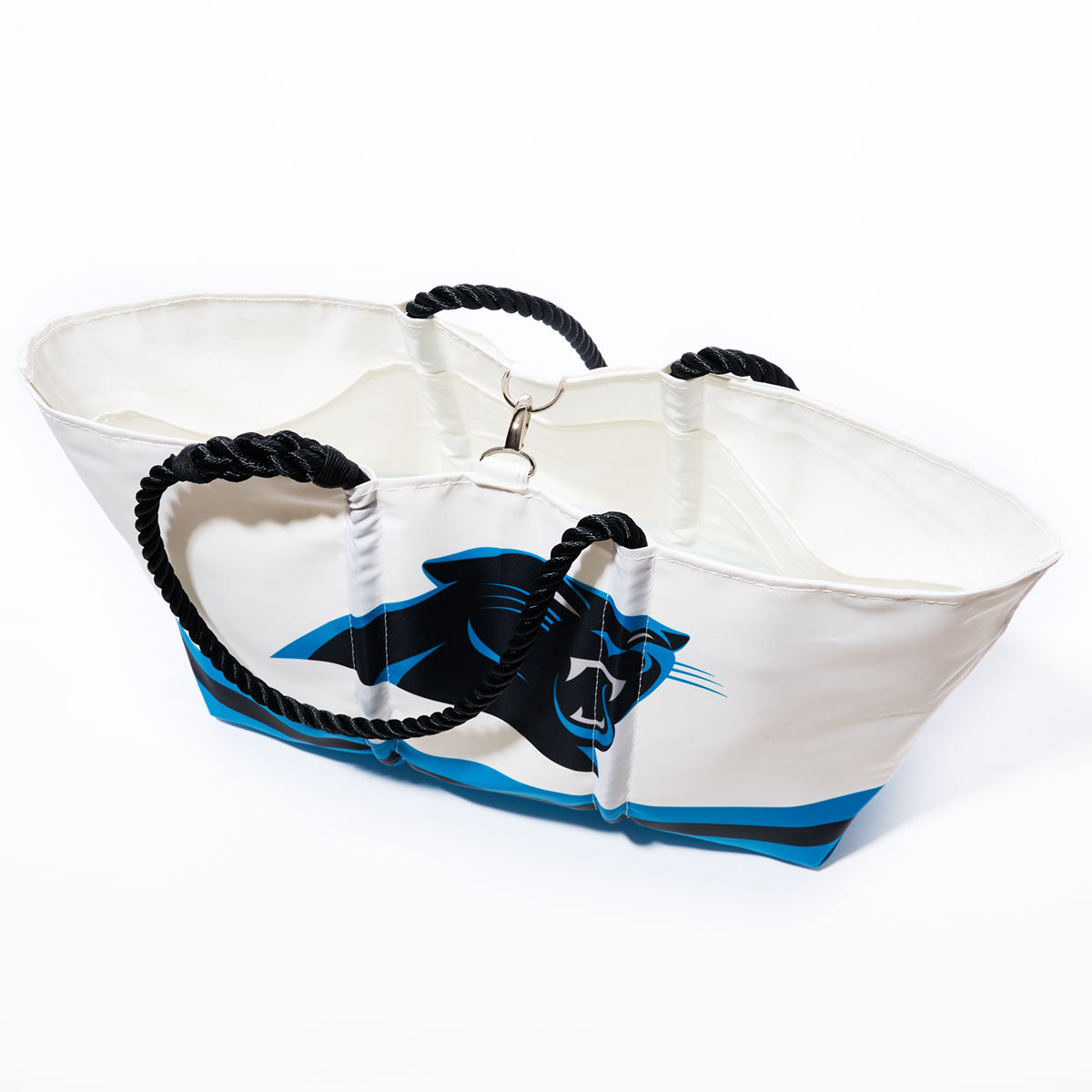 The Sea Bags Carolina Panthers Tailgate Tote is crafted from recycled sail cloth and features black rope handles with a blue and black Carolina Panthers logo on the side. The tote is photographed against a white background. by Sea Bags