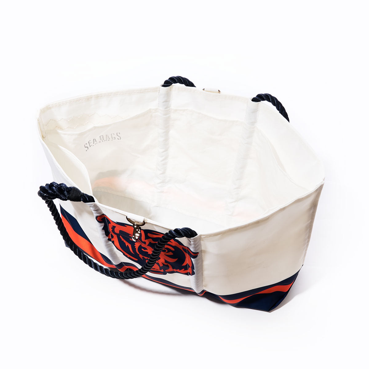 Chicago Bears Tailgate Tote by Sea Bags, made from recycled sail cloth with durable black rope handles and a striking navy, orange, and red graphic on the side, shown against a white background. by Sea Bags