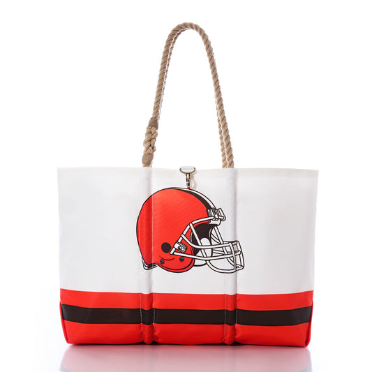 Show off your Cleveland Browns spirit with the Sea Bags Cleveland Browns Tailgate Tote—a white and orange sail cloth tote bag featuring a football helmet graphic, bold brown and orange stripes along the bottom, and sturdy rope handles. Shown against a white background, it’s the perfect accessory for game day. by Sea Bags
