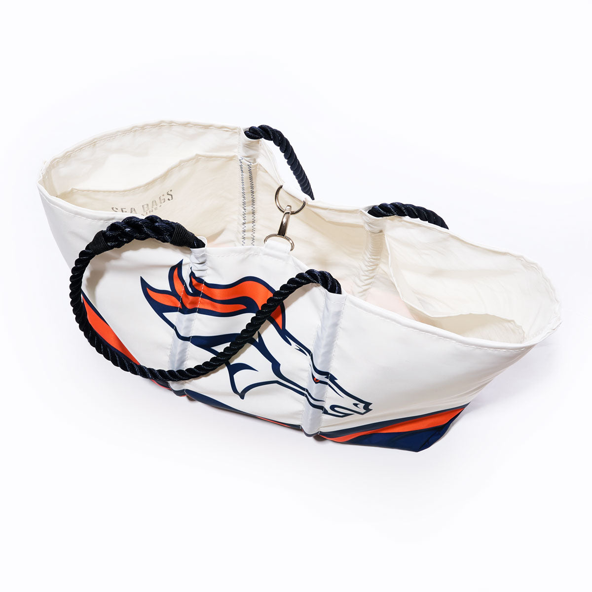 The Denver Broncos Tailgate Tote by Sea Bags is a white recycled sail cloth bag with black rope handles, featuring the team’s logo and orange and blue accents—photographed on a white background, it’s the perfect NFL logo tote for Broncos fans. by Sea Bags