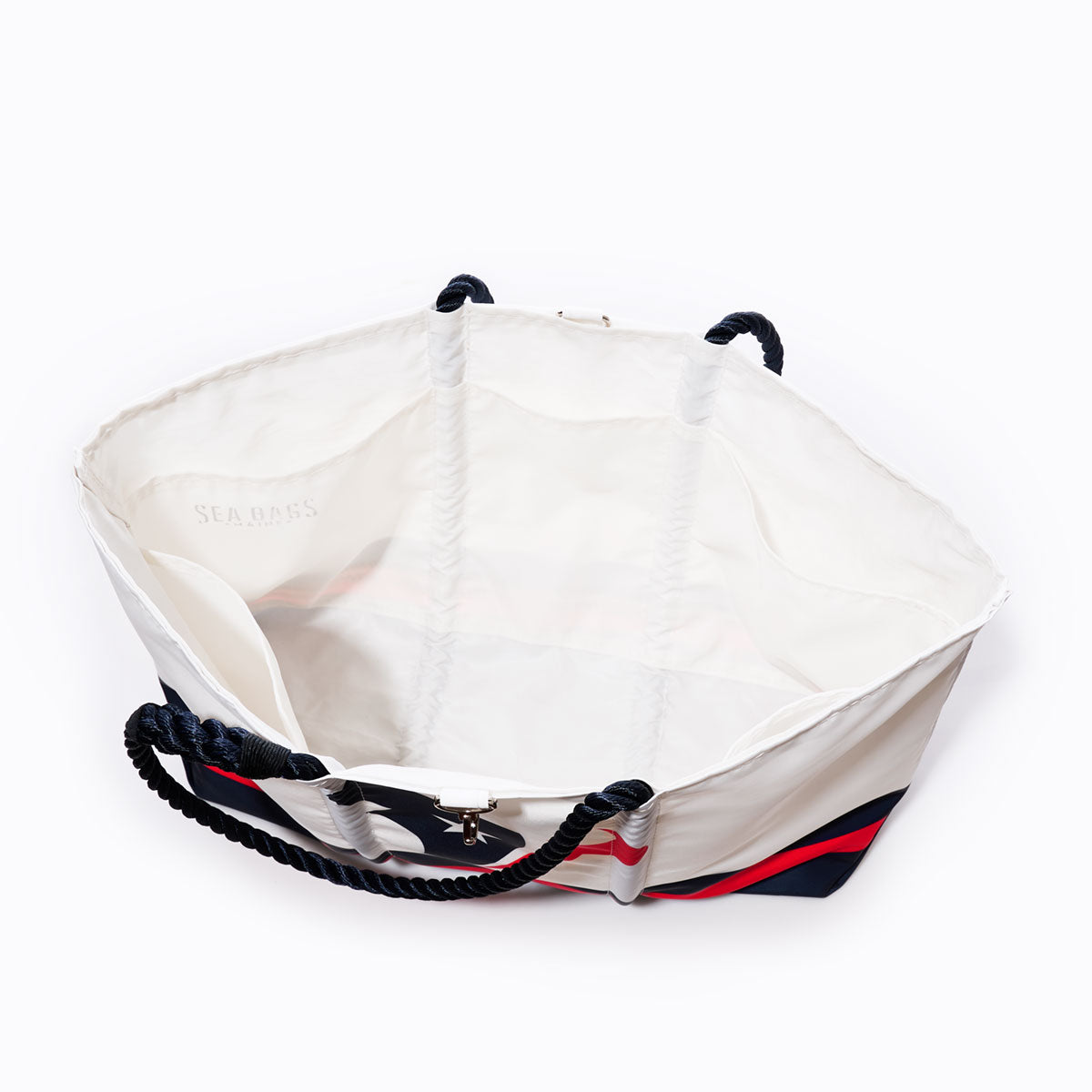 Crafted from recycled sail cloth for style and sustainability, the Sea Bags Houston Texans Tailgate Tote features black rope handles, striking red and black accents, and a spacious open interior—making it the perfect accessory for game day. by Sea Bags