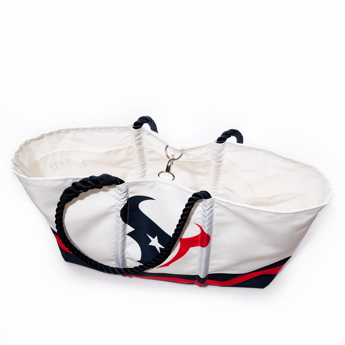 Introducing the Houston Texans Tailgate Tote by Sea Bags—a spacious recycled sail cloth bag in white, accented with black rope handles and a red, navy, and star design. The open-top tote features a roomy interior and a secure metal clasp for your essentials. by Sea Bags