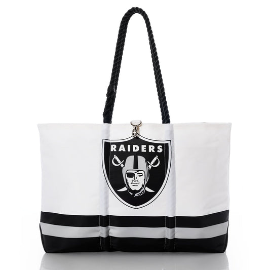 Introducing the Las Vegas Raiders Tailgate Tote by Sea Bags—a white and black tote bag with bold black rope handles, two horizontal black stripes near the bottom, and the iconic Las Vegas Raiders logo. Crafted from recycled sail cloth, this eco-friendly bag is perfect for displaying your Raiders pride in style. by Sea Bags