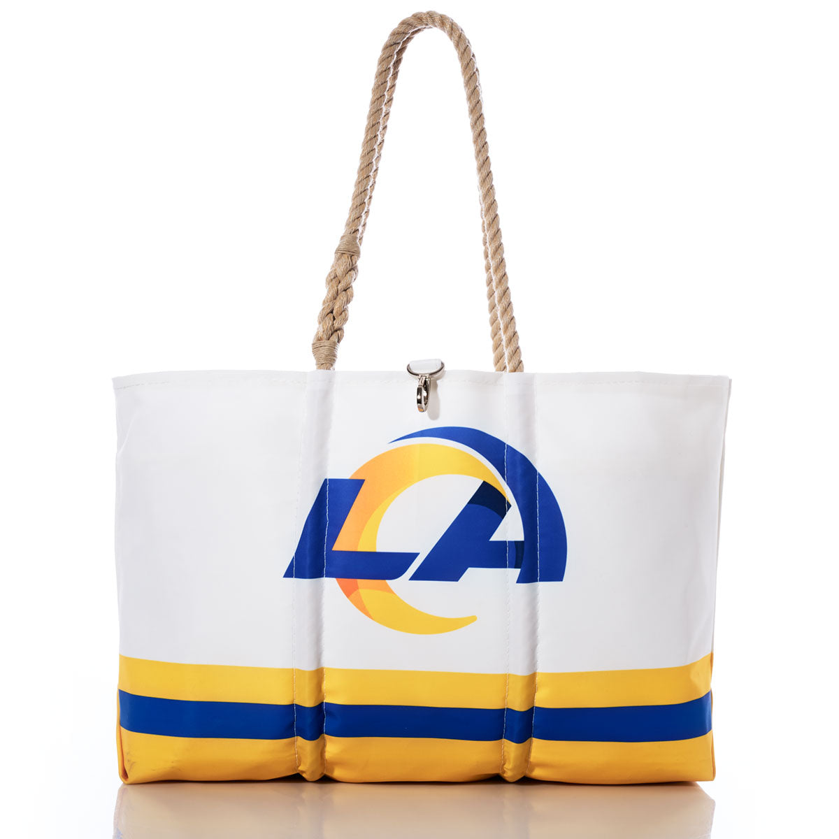 The Los Angeles Rams Tailgate Tote by Sea Bags features yellow and blue stripes, rope handles, and an LA logo on the front. Crafted from recycled sail cloth, this white tote bag is perfect for tailgating, as shown in the product photo set against a white background. by Sea Bags