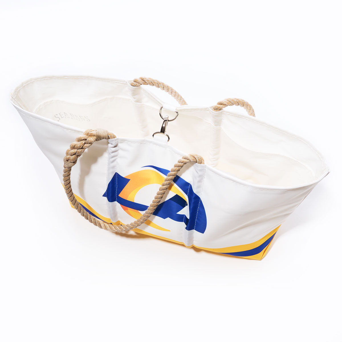 Los Angeles Rams Tailgate Tote by Sea Bags—a white tote bag with rope handles, crafted from recycled sail cloth and featuring a blue and yellow abstract design inspired by the Rams; includes multiple inner pockets and is photographed from above on a white background. by Sea Bags