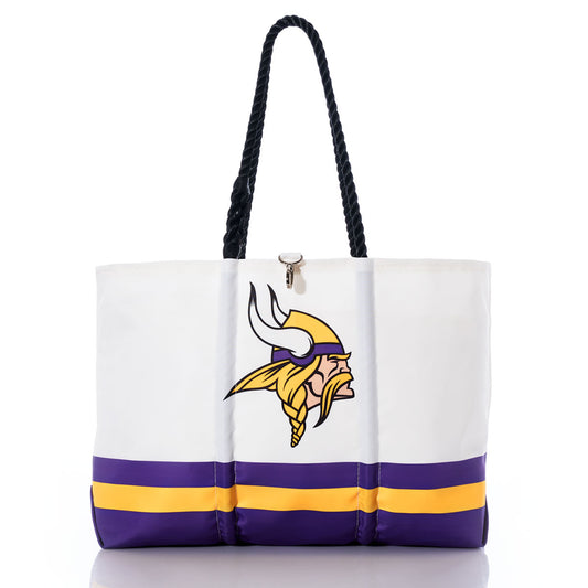 The Sea Bags Minnesota Vikings Tailgate Tote is a white recycled sail cloth bag with black handles, showcasing the Minnesota Vikings logo and purple and yellow stripes near the base. This stylish tote is perfect for any Vikings fan who values both team spirit and sustainability. by Sea Bags