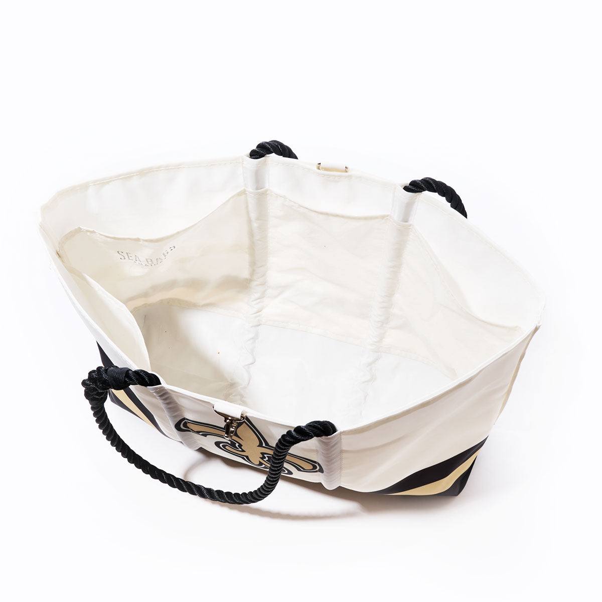The Sea Bags New Orleans Saints Tailgate Tote, made from recycled sail cloth, features black rope handles and a bold black and gold emblem reminiscent of the Saints, shown open and empty from above against a white background. by Sea Bags