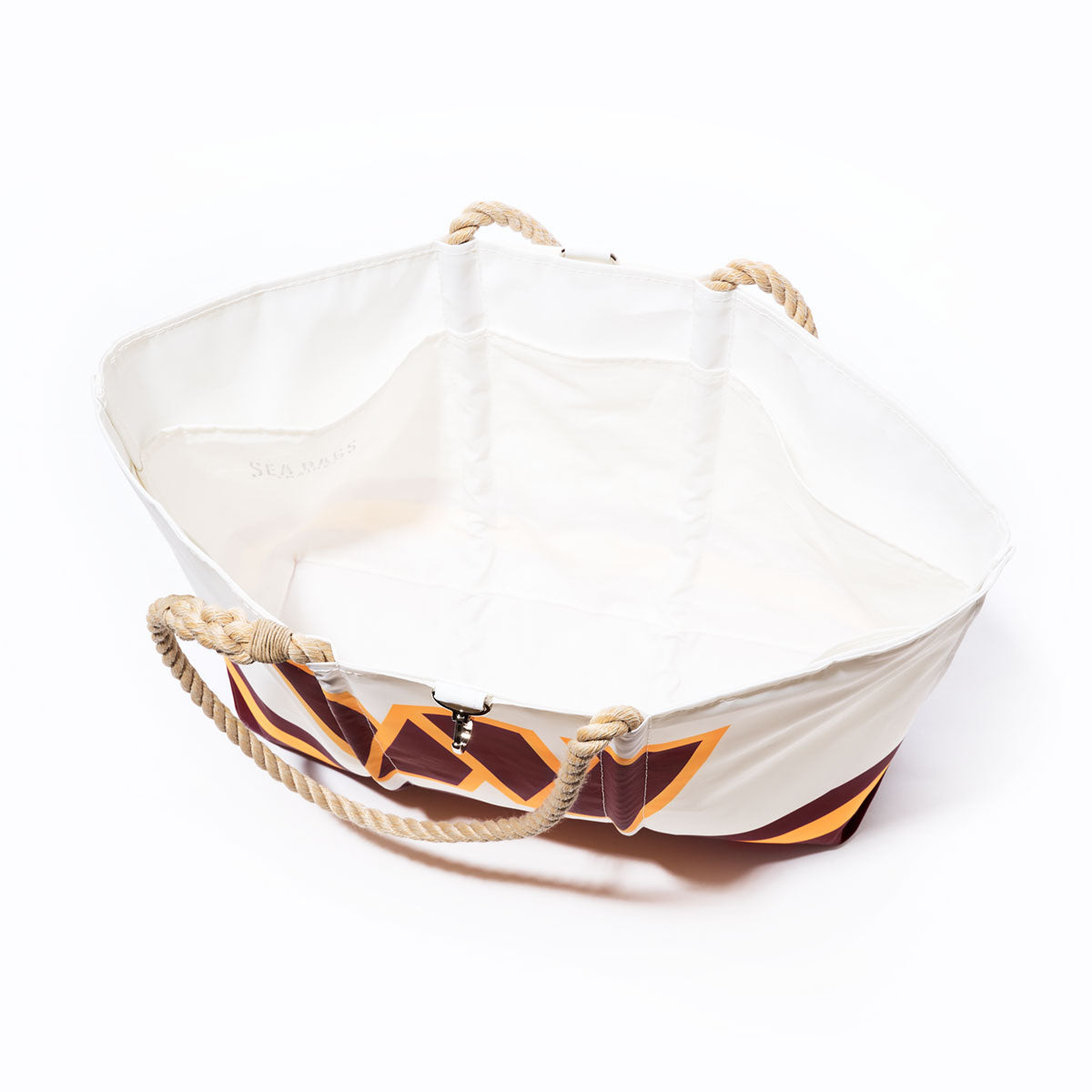 Sea Bags Washington Commanders Tailgate Tote: A spacious, open white canvas tote bag made from recycled sail cloth, featuring sturdy rope handles and a bold geometric orange and purple pattern inspired by the Washington Commanders’ colors, photographed against a white background. by Sea Bags