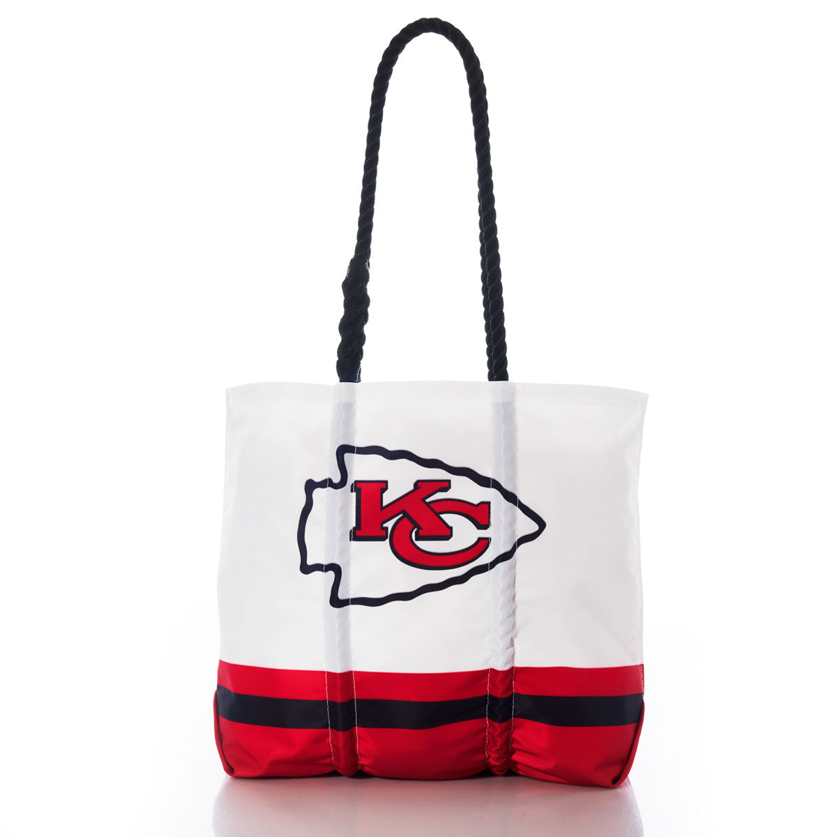 Introducing the Kansas City Chiefs Medium Tote by Sea Bags—a white recycled sail cloth tote with black handles, featuring sturdy red and black bottom stripes and a bold Kansas City Chiefs logo on the front. This eco-friendly, durable bag is perfect for fans. by Sea Bags