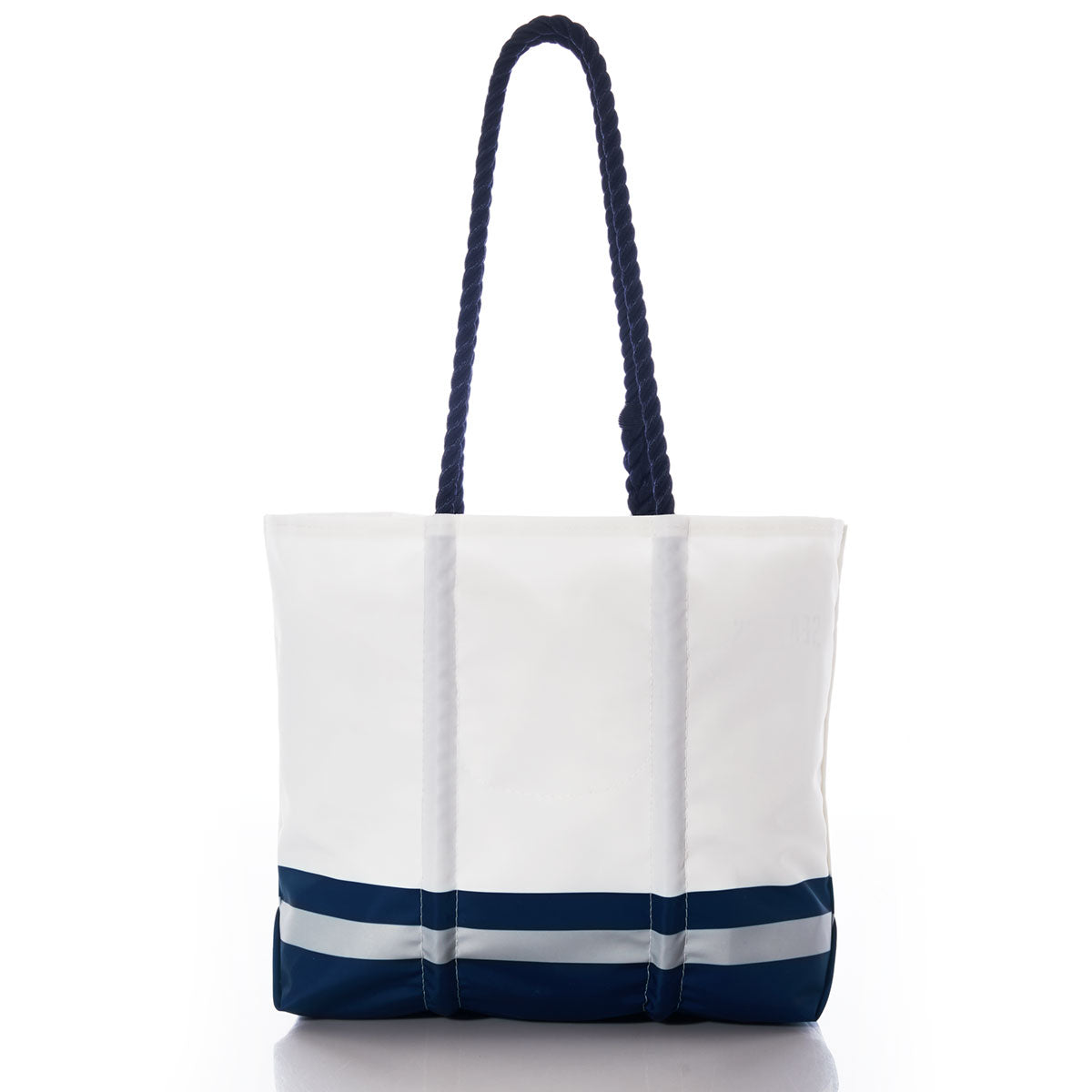 The Sea Bags Dallas Cowboys Medium Tote is a white and navy blue durable tote bag featuring rope handles, vertical white straps, and two horizontal stripes near the bottom. Made from recycled sail cloth, this versatile bag combines style and sustainability, shown here against a plain white background. by Sea Bags