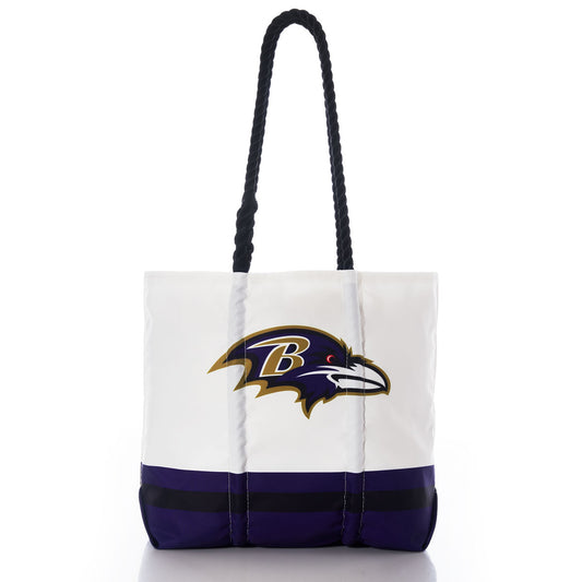 Show your Maryland pride with the Baltimore Ravens Medium Tote by Sea Bags. This white tote bag features sturdy black handles, the official Baltimore Ravens logo, and bold purple accents at the bottom. Crafted from durable materials, this stylish and functional tote is perfect for everyday use. by Sea Bags
