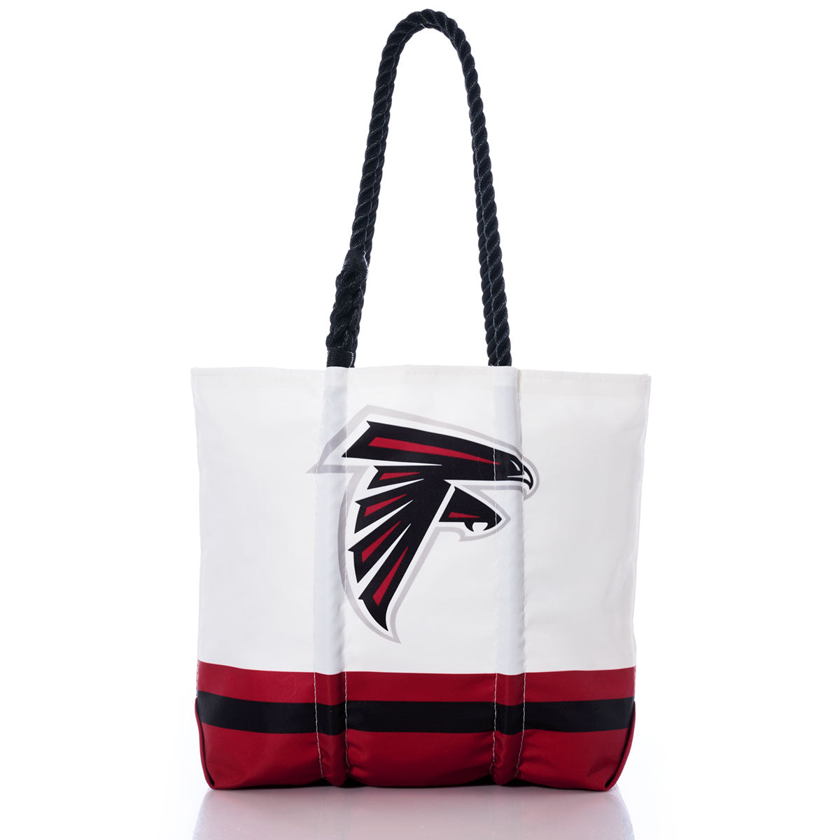 Introducing the Atlanta Falcons Medium Tote by Sea Bags—a white tote featuring black rope handles and striking red and black stripes along the bottom. The front showcases a bold black and red falcon head logo, making it the perfect accessory for any fan. Expertly crafted from recycled sail cloth, this eco-friendly tote combines style with team pride for every outing. by Sea Bags