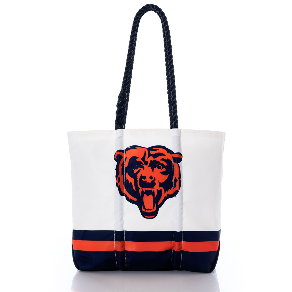 The Chicago Bears Medium Tote by Sea Bags is crafted from recycled sail cloth and features a white design with navy and orange stripes at the bottom, a bear head logo in the center, and two thick, rope-style black handles—combining eco-friendly materials with team spirit. by Sea Bags