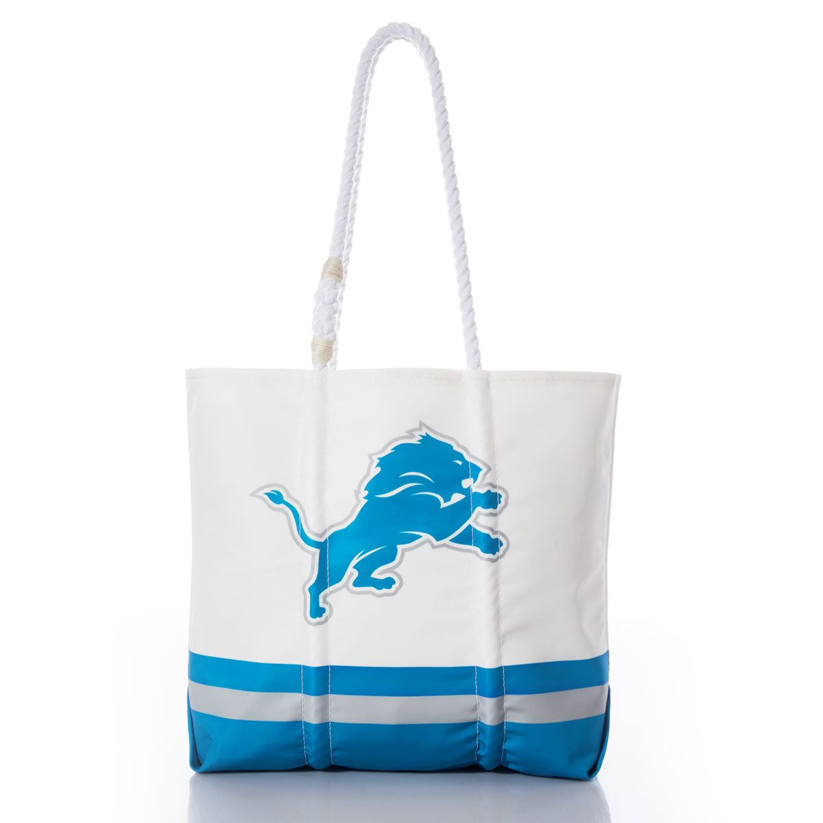 The Sea Bags Detroit Lions Medium Tote features a sturdy white and blue design crafted from recycled sail cloth, accented with rope handles and a bold blue lion logo on the front—an eco-friendly and stylish accessory for any Detroit Lions fan. Pictured on a white background. by Sea Bags