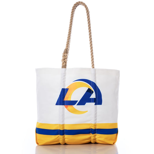 Sea Bags Los Angeles Rams Medium Tote, featuring a blue and yellow team logo, coordinating stripes at the bottom, and durable brown rope handles, crafted from recycled sail cloth and photographed on a white background. by Sea Bags