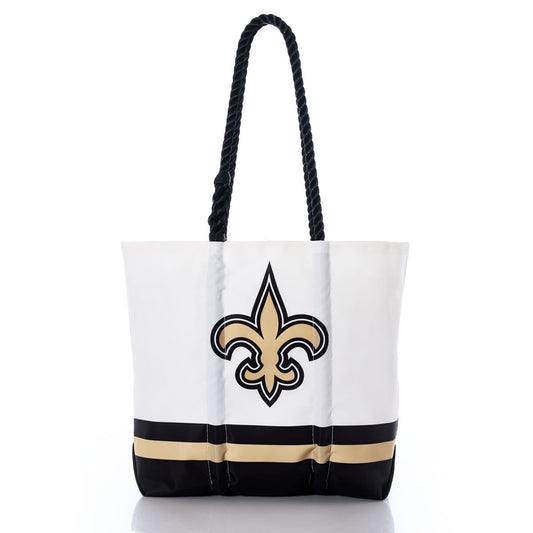 The New Orleans Saints Medium Tote by Sea Bags is made from recycled sail cloth and features bold black and gold bands at the base, sturdy black rope handles, and a large black and gold fleur-de-lis emblem on the front—an ideal choice for Saints fans seeking a sustainable and stylish accessory. by Sea Bags